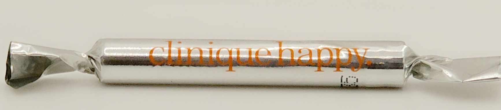 Clinique Happy fragrance sample wrapped in silver foil with orange logo, promotional mini perfume Ghbb Trading